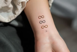 Three different infinity symbols in gold, silver, and bronz tattoo idea