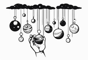 Human hand dangling planets from fingertips tattoo idea