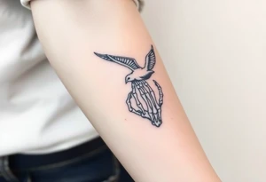 Skeleton hand reaching out of the ocean for a flying swallow tattoo idea