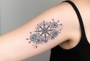 Abstract Compass surrounded with wild flowers tattoo idea