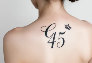 Capital G letter handwritten script with a crown tilted to the left on the front right shoulder on top of a number 45 tattoo idea