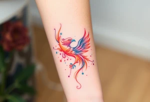Phoenix with splashes of color in fire tattoo idea