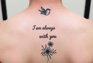 Bible verse “I am always with you Matthew 28:20” going vertical down the spine  with a dainty bird on top with small flowers on the bottom tattoo idea