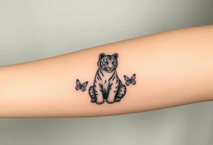 Tiger cub sitting down with paw up and on the paw is sitting a butterfly and there’s two butterflies on each side tattoo idea