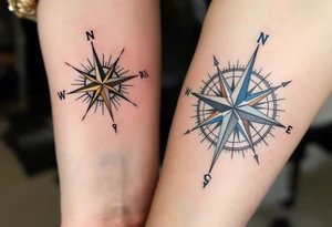 One wears a compass pointing north in black and gold, the other a compass pointing south in silver and blue, symbolizing guidance and connection. tattoo idea