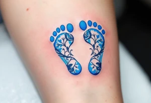 A pair of tiny blue footprints with the son's name in elegant black script beneath. tattoo idea
