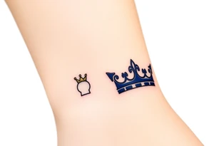 A tiny crown for the child and a regal crown for the parent, in soft gold and deep royal blue, symbolizing unconditional love and royalty tattoo idea