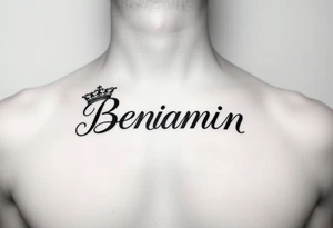 The name Benjamin with a kings crown at the front of the word, on the left side of a women’s chest above the heart  in cursive tattoo idea