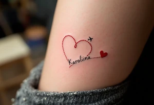 A dotted-line heart in red ink with a tiny plane drawing a trail spelling Karolína. tattoo idea
