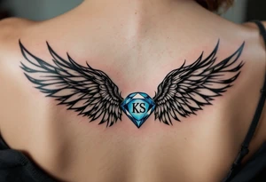 A pair of black ink wings cradling a small, blue gem with the son’s initials KS inside. tattoo idea