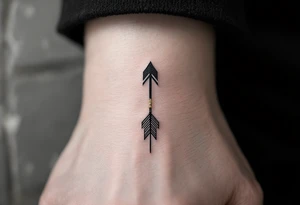 A sleek black ink arrow with a delicate gold accent running along its shaft, symbolizing elegance and direction. tattoo idea