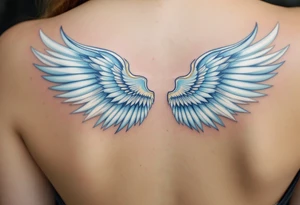 A graceful guardian angel with large feathered wings. The color palette includes light blue, silver, and soft white, symbolizing Virgo’s protective and pure energy. tattoo idea