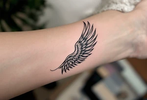 beautiful strong angel wing with word "Warrior" tattoo idea