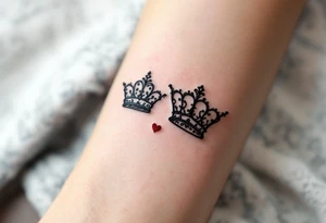 Ornate filigree-style black crowns with small deep red heart designs beneath each. tattoo idea