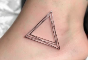 A hollow triangle made of thin silver lines, floating elegantly on the skin like jewelry. tattoo idea