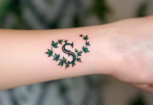 A pinky "S" entwined with green ivy leaves, symbolizing growth and elegance. tattoo idea
