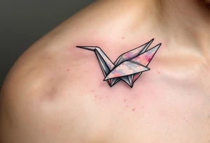 A delicate paper crane folded from pastel watercolor folds, symbolizing peace and free will. tattoo idea