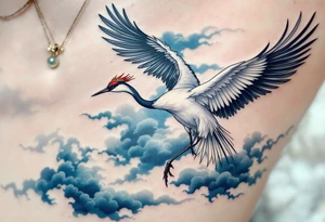 A white crane with black wing tips and red crown flying through misty blue clouds. tattoo idea