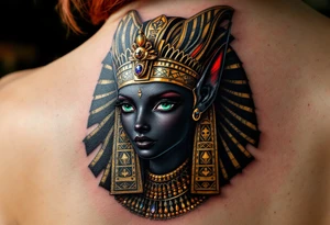 A black Anubis head with emerald green eyes and a royal gold headdress. tattoo idea