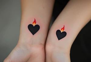 Black hearts with a small red flame above them on each wrist to represent burning love. tattoo idea