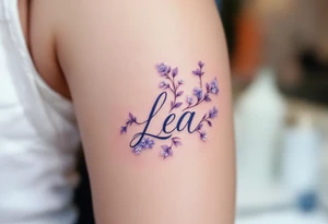 Lea name written in elegant script, surrounded by delicate lilac vines with small white blossoms. tattoo idea