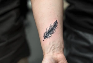 A single soft grey feather drifting down the forearm, capturing the lightness of freedom. tattoo idea