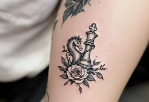A fine-line black and gray tattoo of a chess king and queen piece intertwined with red roses. tattoo idea