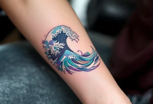 A wave inked in swirling tones of aquamarine and lavender hugs the inner forearm. tattoo idea