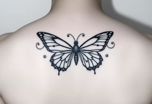 dainty butterfly with swirls coming from both wings tattoo idea