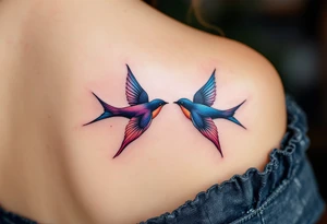 Stylized swallows in dusty rose and deep blue flying toward each other on the back shoulders signify freedom and loyalty. tattoo idea