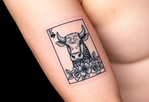A king play card with a small highland cow face on it and a small 4 leaf clover surrounded by roses tattoo idea
