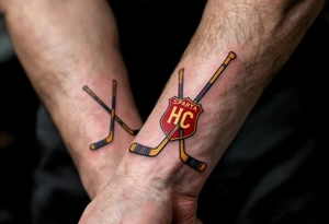 Two crossed hockey sticks with the HC Sparta crest in deep red and yellow centered on the wrist. tattoo idea