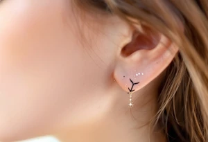 A subtle Sagittarius tattoo using only tiny white dots for stars, placed behind the ear. tattoo idea