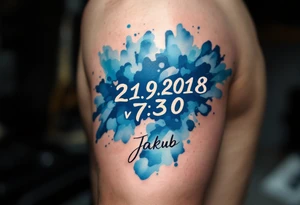 Bold numbers "21.9.2018 v 7:30" with the name "Jakub" beneath, surrounded by a blue watercolor splash. tattoo idea