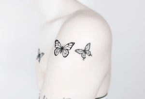 Show me an upper arm/shoulder/shoulder blade tattoo design with a birth flower for July, July, January, September, and 3 butterflies, and a raven and an eagle tattoo idea