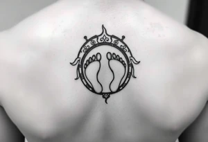 Tribal tattoo in ring/band with Ghanaian symbols as well jamaica incorporated with 4 baby foot prints tattoo idea