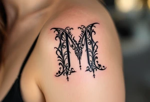 A bold blackletter-style "M" in deep onyx black with sharp gothic edges. tattoo idea