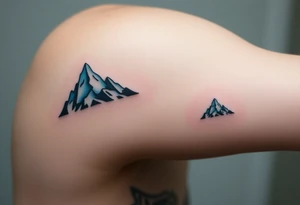 A pair of minimalist black and blue mountain peaks, one tattooed on the father’s forearm and the matching smaller version on the child’s. tattoo idea