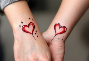 A red candy-heart design on each partner wrist tattoo idea