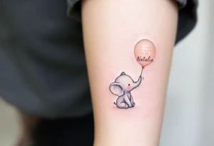 Delicate outline of a baby elephant holding a balloon with name Natálie and numbers 22.10.2023 v 5:15 in pastel peach script. tattoo idea
