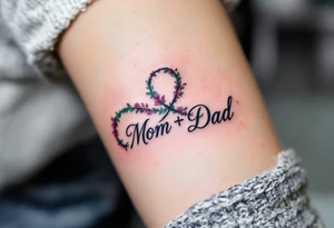 A delicate infinity symbol in violet and emerald green with “Mom + Dad” intertwined. tattoo idea