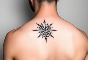 intricate compass rose on upper right back shoulder of a man. black and white. tattoo idea
