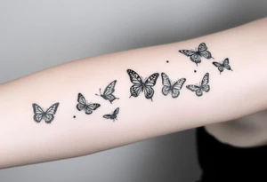 Six different butterflies streaming down arm with six kids names Aden, Aninna, Novaih, Rayla, Jayla, Teresa tattoo idea