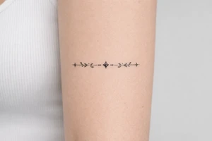 neckline tattoo along the collarbone tattoo idea