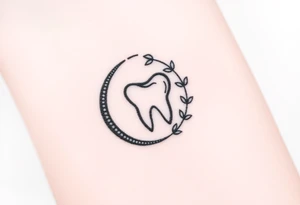 Tiny molar tooth outlined in black, framed by a crescent moon made of intertwining ivy leaves, soft stippled shading only at the crescent’s base.” tattoo idea