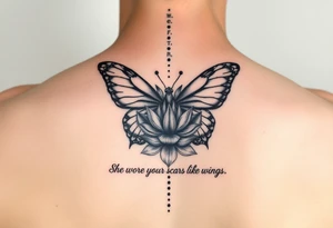 butterfly with cracked wings and lotus flower with quote that says “she wore her scars like wings” all down spine but very elegant tattoo idea