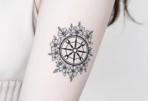 Compass surrounded with flowers cursive letters tattoo idea