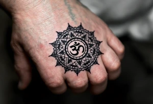 wheel of Dharmachakra with an ohm symbol in the middle tattoo idea