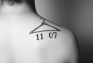 I want a tattoo about 7 cm in size that includes a drawing of a clothes hanger and the numbers 11 07, all in a realistic, beautiful style with stylish lettering tattoo idea