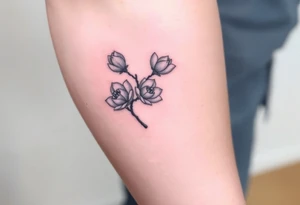 Branch with few magnolia flowers, in different blossom stages tattoo idea